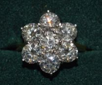 A VERY GOOD 18CT YELLOW GOLD AND DIAMOND SEVEN STONE FLOWER HEAD RING, each diamond approx half a