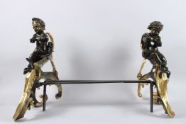 A VERY GOOD PAIR OF LOUIS XVITH BRONZE AND ORMOLU CHENETS with bronze cupids and ormolu scrolls.