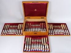 A SUPERB SET OF TWENTY FOUR VICTORIAN SILVER AND PORCELAIN DESSERT KNIVES AND FORKS. London 1881.