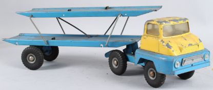 A TIN PLATE FLAT BED CAR TRANSPORTER, blue and yellow. 64cms long.