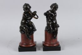 A SUPERB PAIR OF BRONZE CUPIDS playing a flute and horn, on square marble bases. 9ins high.