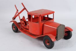 A TRI-ANG RED TINPLATE CRANE LORRY. 40cms long.