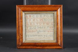 A FRAMED VICTORIAN NEEDLEWORK SAMPLER. 6ins x 6ins.