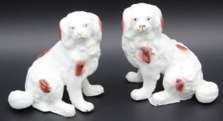 A PAIR OF PORCELAIN KING CHARLES SPANIELS. 4.5ins high.