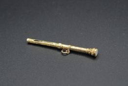 A GOLD PENCIL 2.5ins long.