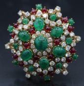 A GOOD 18CT GOLD STAR BROOCH set with rubies, emeralds and diamonds. 2ins diameter. 41grams.