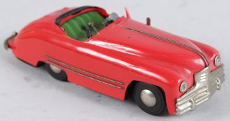 A TRI-ANG RED BUICK CAR. 20cms long.