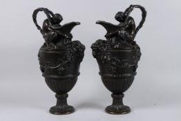 A SUPERB PAIR OF CLASSICAL BRONZE EWERS with male nude, ram's masks and fruiting vines. 16ins high.