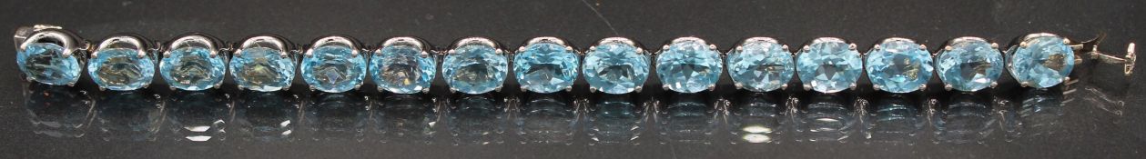 A VERY GOOD 18CT WHITE GOLD TOPAZ LINE BRACELET set with fifteen topaz. 6.5ins long. 32grams.