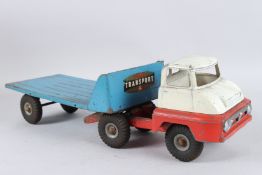 A TRI-ANG FLAT BED TRUCK. Cream, red and blue. 60cms long.