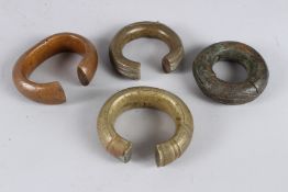 FOUR AFRICAN BRASS BRACELETS