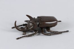 A JAPANESE BRONZE OKIMONO RHINO BEETLE with articulated wing. 10cm long