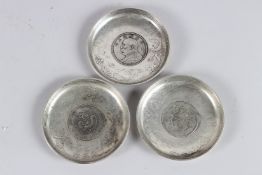 THREE CHINESE WHITE METAL COIN DISHES 9cm diameter