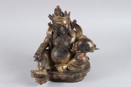A TIBETAN GILT BRONZE STATUE OF DZAMBALA 26cm high