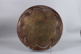 A 19TH CENTURY PERSIAN HAND CARVED BRASS CIRCULAR TRAY. 19ins diameter