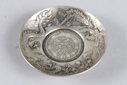 A CHINESE WHITE METAL COIN DISH 9cm diameter
