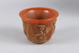 A GOOD CARVED HORN CIRCULAR BOWL the sides carved with figures 10cm diameter