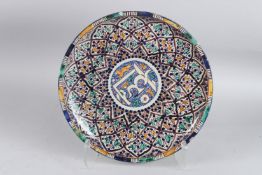 A LARGE ISLAMIC POTTERY CIRCULAR DISH with calligraphy 33cm wide