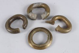 FOUR AFRICAN BRASS BRACELETS