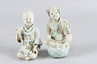 A PAIR OF CHINESE YINQUING GLAZE CHILDREN. 15cm high