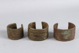 THREE AFRICAN BRASS BRACELETS