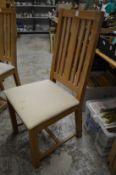 A set of eight modern oak high back dining chairs.