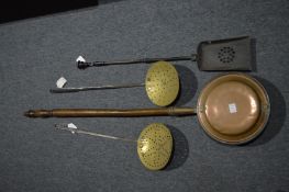 Two brass skimmers, fireside shovel and a copper bed warming pan.