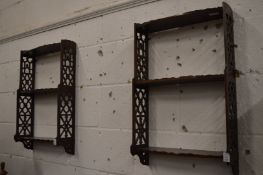 A pair of mahogany fretwork wall shelves.