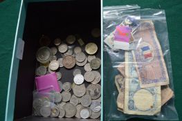 A box of various bank notes and coins.