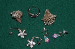 Three pairs of silver earrings and a ring.