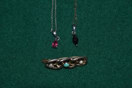 A brooch, two chains and a pendant.