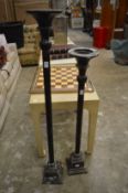 Two floor standing candle holders.