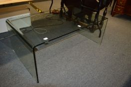 A stylish bent glass coffee table.