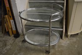 A chrome and glass two-tier drinks trolley.