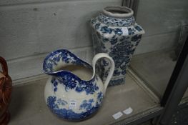 A blue and white jug and a modern blue and white vase.