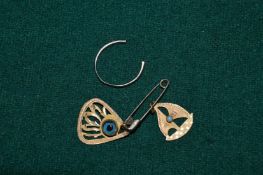 An 18ct gold part ring band and two yellow metal pendants.