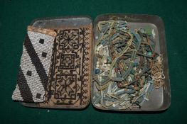 An old tobacco box containing Egyptian bead necklaces etc.