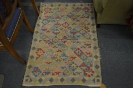 A geometric embroidered rug, 115cm x 77cm.