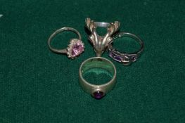 Four various silver rings.