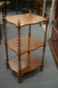 A Victorian rosewood three-tier whatnot with barley twist supports.