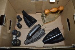 A good early brass box iron, three flat irons and two pairs of opera glasses.