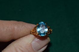 A gilded silver ring set with a 7.5ct oval cut blue topaz.