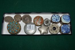 Decorative silver and other pill boxes.