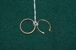 An 18ct gold wedding band and a part band of a ring.