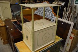 A decoratively painted two-tier occasional table with cupboard.