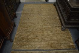 A modern Jute woven rug, 220cm x 155cm.