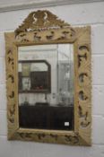 A large decorative mirror with carved and painted frame.