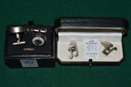 Two pairs of cufflinks.