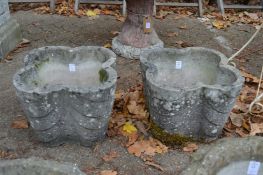 A pair of quatrefoil shaped reconstituted stone garden planters.