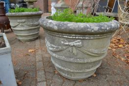 A very good large pair of weathered reconstituted stone circular garden urns of classical style.